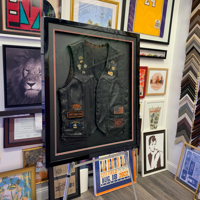 Framed leather motorcycle jacket in a deep shadow box frame by Modern Memory Design, Hasbrouck Heights NJ