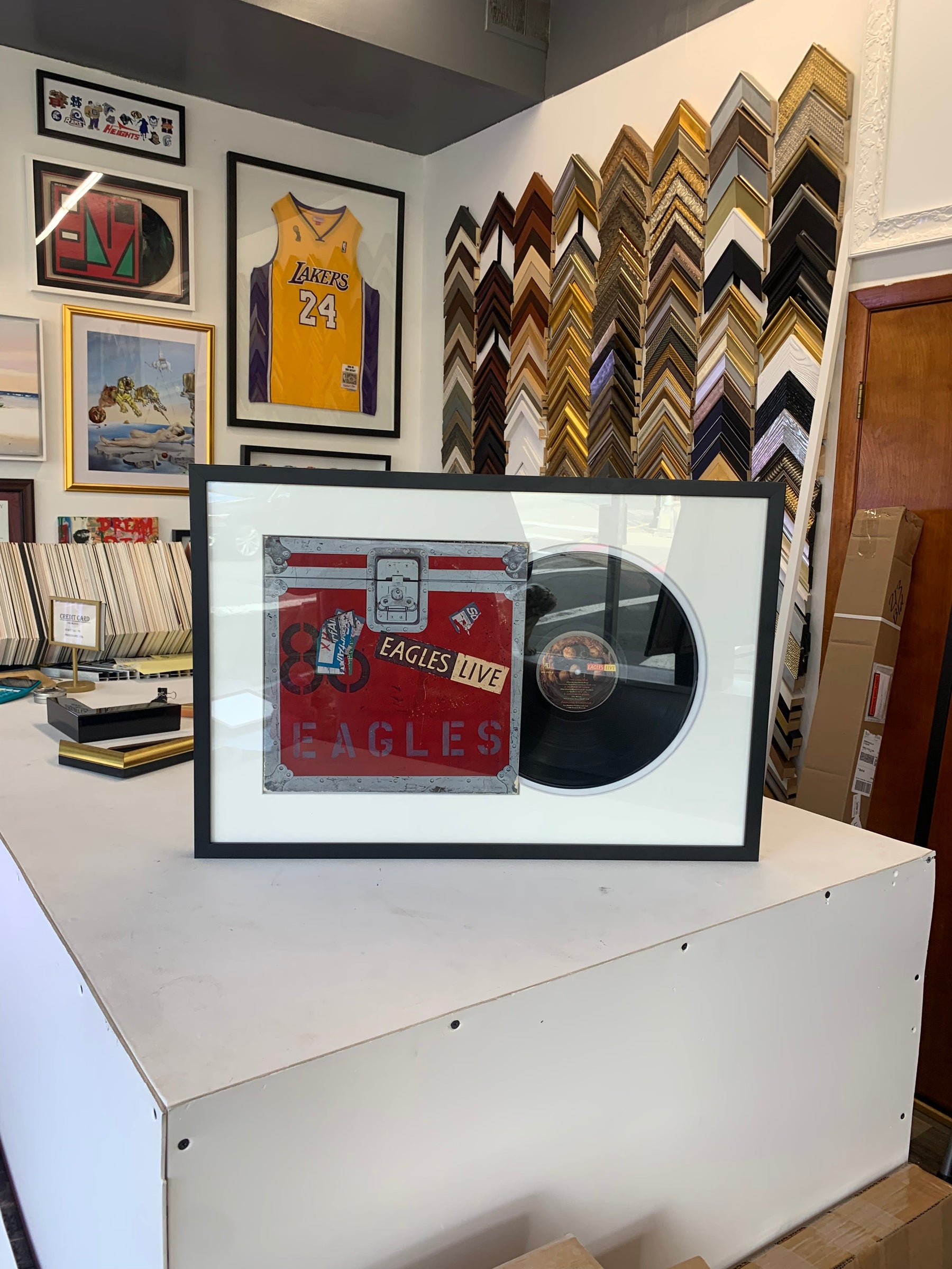 Vinyl record and album cover displayed in a custom record frame