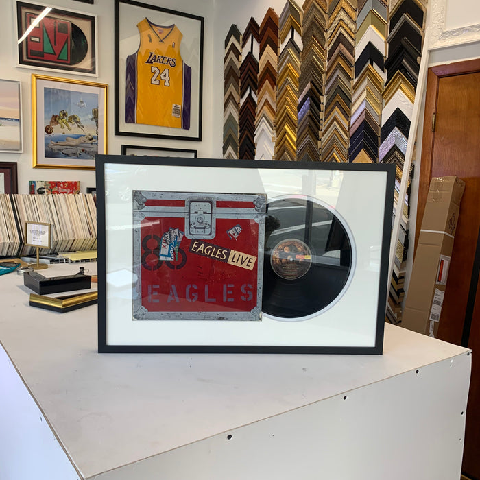 Vinyl record and album cover displayed in a custom record frame
