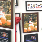 Wall hanging featuring framed photographs in a 47x26 brown wood picture frame