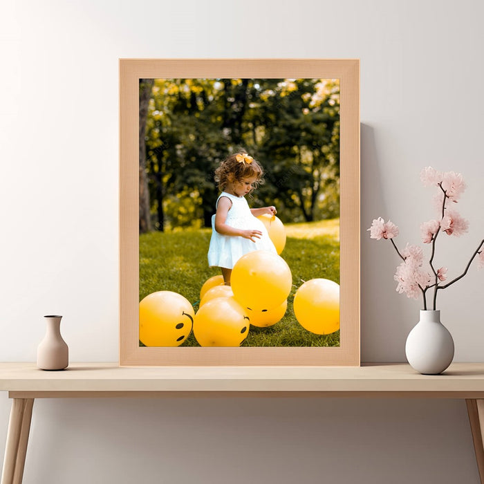 a picture of a little girl in a blue dress surrounded by yellow balloons